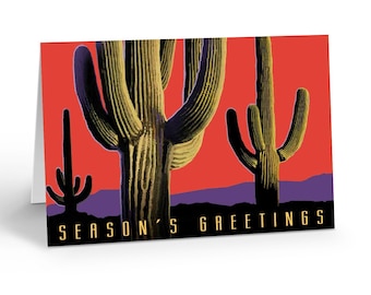 May include: A Christmas card with a red background featuring three silhouetted saguaro cacti with yellow and green accents. The text "Season's Greetings" is printed in yellow at the bottom of the card.