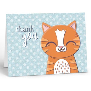 May include: A thank you card with a cute orange and white cat with a happy expression on a light blue background with white snowflakes.