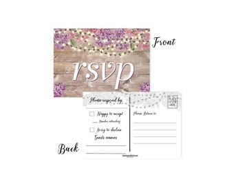 May include: A rustic wooden background with a floral garland and string lights. The text "RSVP" is written in large letters. The back of the card has a lace pattern and a section for guests to RSVP with their names and number attending.