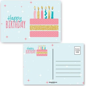 May include: A light blue postcard with a pink and gold cake with candles on the front. The back of the postcard has a space for a stamp and a message. The text on the front of the postcard says "Happy Birthday".