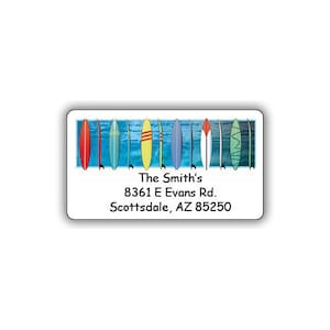 May include: A white address label with a colorful image of surfboards on a blue background. The text on the label reads "The Smith's 8361 E Evans Rd. Scottsdale, AZ 85250".