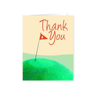 May include: A thank you card with a golf green and a golf ball on the green. The card has the words "Thank You" written in orange.