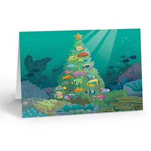 May include: A folded greeting card featuring a vibrant underwater scene with a triangular Christmas tree shape formed by various colorful tropical fish. The tree is topped with a gold star, set against a teal ocean background with coral reefs.