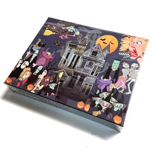 May include: A colorful illustration of a haunted house with a variety of spooky characters, including a witch, a ghost, a skeleton, and a monster. The text on the box reads "Oh no! EEK! AHH! screeeeech!"