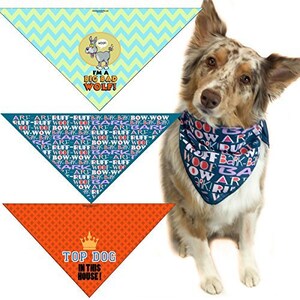May include: A dog wearing a blue bandana with the words "ARF-ARF RUFF-RUFF BARK-BARK BOW-WOW" repeated in pink and purple. The dog is also wearing a green bandana with the words "I'M A BIG BAD WOLF!" and a red bandana with the words "TOP DOG IN THIS HOUSE!"