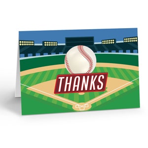 May include: A baseball thank you card with a baseball on a green baseball field with a red banner that says "THANKS".