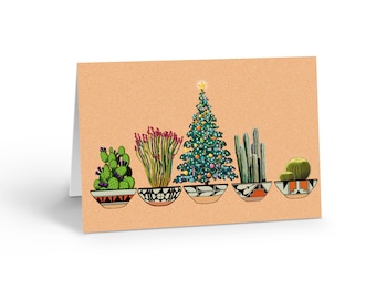 May include: A greeting card with a light orange background featuring an illustration of five potted plants in a row. The plants include a prickly pear cactus, a tall flowering plant, a decorated Christmas tree, a columnar cactus, and a round cactus.