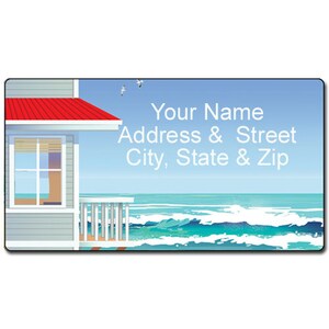 May include: A beach house with a red roof and white trim sits on a sandy beach with blue ocean waves crashing in the background. The text "Your Name Address & Street City, State & Zip" is printed on the image.