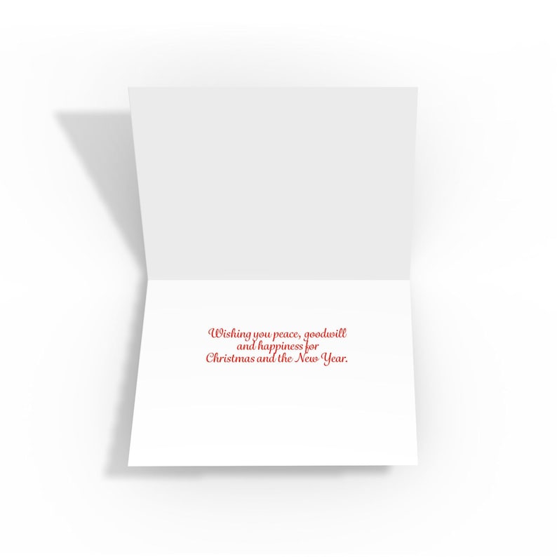 The inside of a folded white greeting card reads, "Wishing you peace, goodwill and happiness for Christmas and the New Year."