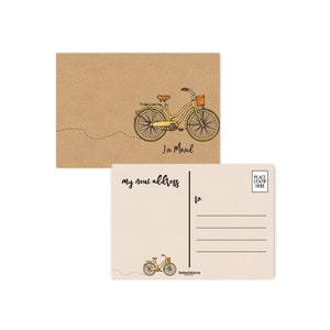 May include: Two postcards with a bicycle theme. One card is kraft paper with a yellow bicycle illustration and the text "I've Moved". The other card is cream-colored with lines for an address and the text "my new address".