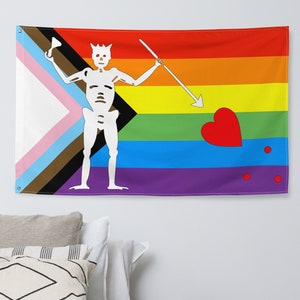 May include: A colorful flag with a rainbow design and a skeleton holding a spear. The flag also features a heart and two red dots.