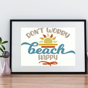 May include: A framed print with a white background and the text "Don't Worry Beach Happy" in a blue, orange, and yellow color scheme. A stylized sun with rays is above the word "beach".