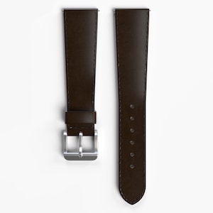 May include: A pair of brown leather watch straps with silver buckles. The straps are designed for a wristwatch.