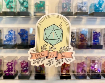 May include: A sticker with a light green 20-sided die with a 1 on it. The die is surrounded by a yellow and white frame with a banner that says "Guess I'll Die..." in black text.