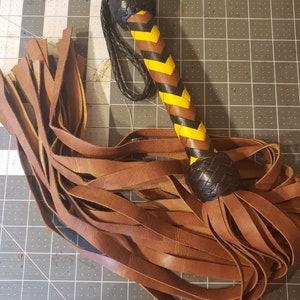 Brown flogger with yellow and black handle