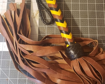 Brown flogger with yellow and black handle