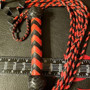 Red and black cat o nine tails flogger