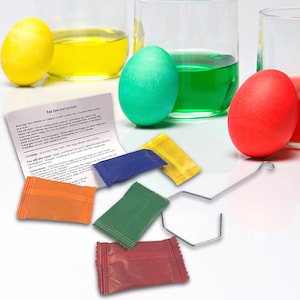 May include: A set of colourful egg dye packets with instructions for dyeing eggs. The packets are red, green, blue and yellow. The instructions include a warning that the dye is not suitable for children under 8 years old.