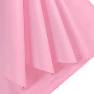 May include: A stack of pink tissue paper, folded and arranged in a fan shape. The paper is soft and delicate, with a subtle sheen.