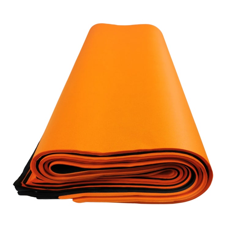 May include: A roll of bright orange foam with black edging. The foam is rolled up and is ready to be unrolled.
