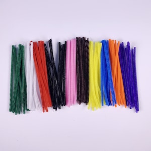 May include: A collection of colourful pipe cleaners in various colours, including green, white, red, black, pink, brown, yellow, blue, orange, and purple.