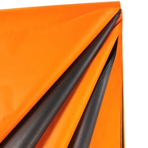 May include: Orange and black tissue paper, folded in a triangular shape. The tissue paper is soft and delicate, perfect for wrapping gifts or adding a touch of color to your crafts.