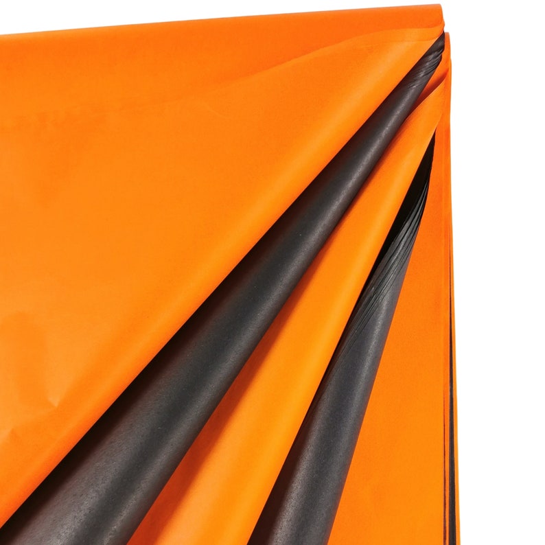 May include: Orange and black tissue paper, folded in a triangular shape. The tissue paper is soft and delicate, perfect for wrapping gifts or adding a touch of color to your crafts.