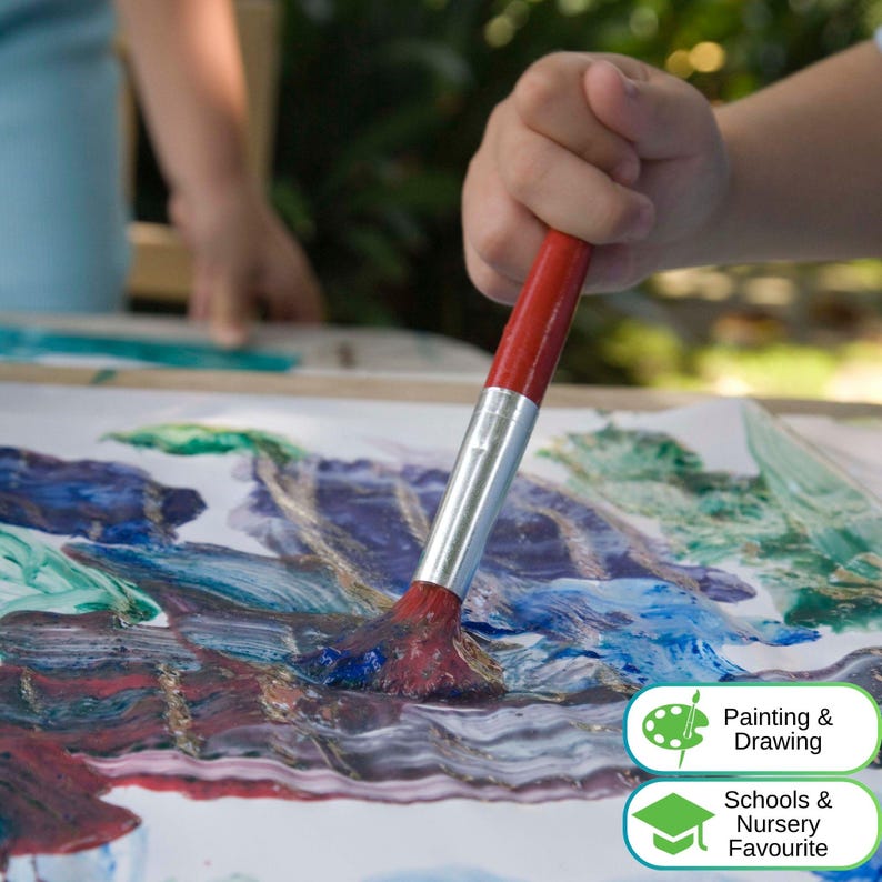 May include: A paintbrush with a red handle and a silver ferrule applying blue, green, and purple paint onto a white sheet of paper. The image includes text labels that read Painting & Drawing and Schools & Nursery Favourite in the corner.