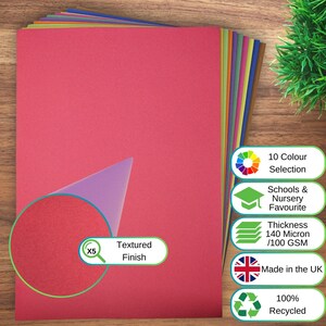 May include: A stack of multi-coloured paper sheets with a textured finish. The top sheet is pink. Text on the image includes 10 Colour Selection, Schools & Nursery Favourite, Thickness 140 Micron/100 GSM, Made in the UK, 100% Recycled, and Textured Finish.