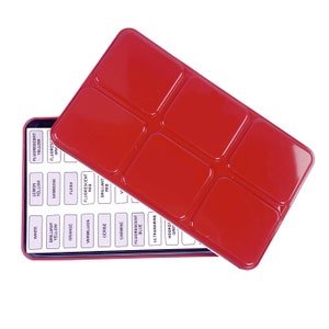 May include: A red metal paint box with a white lid. The lid is open and shows the names of the paint colors: White, Lemon Yellow, Brilliant Yellow, Gamboge, Orange, Flesh, Vermillion, Cerise, Carmine, Fluorescent Blue, Ultramarine, Hookers Green.