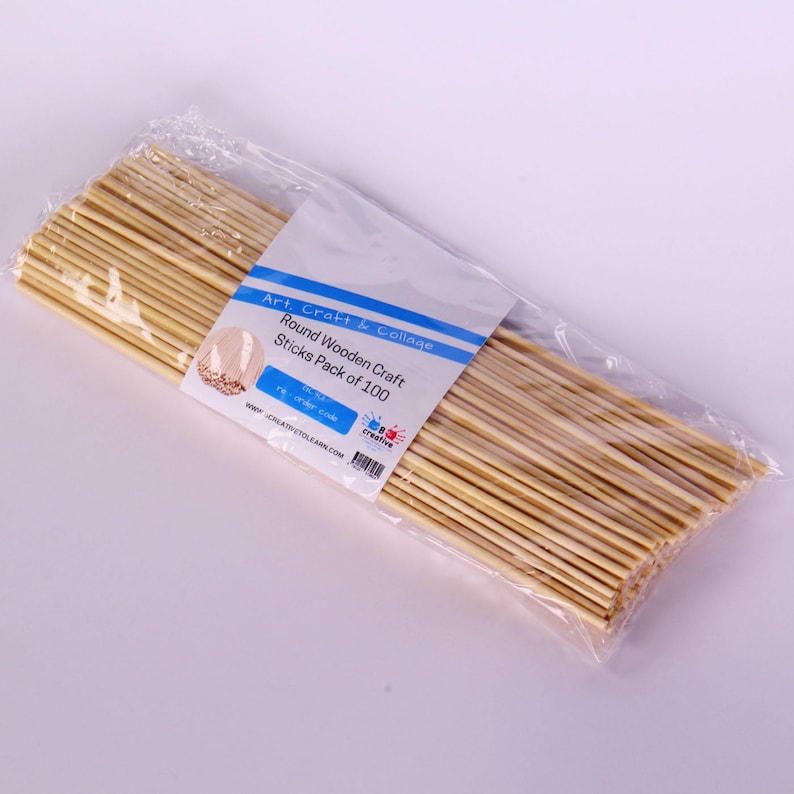 May include: A clear plastic bag filled with 100 natural wooden craft sticks. The bag has a label that reads "Art, Craft & Collage Round Wooden Craft Sticks Pack of 100".