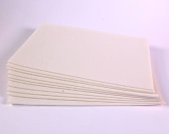 May include: A stack of white felt sheets, perfect for crafting projects.