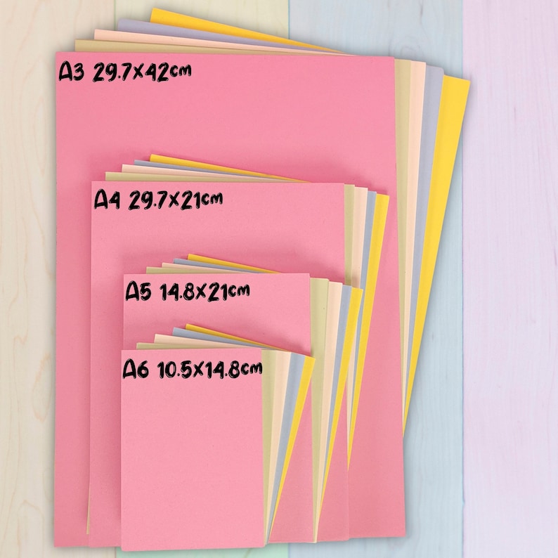 May include: A stack of colorful paper in various sizes, including A3 (11.7x16.5 inches), A4 (8.3x11.7 inches), A5 (5.8x8.3 inches), and A6 (4.1x5.8 inches). The paper is pink, yellow, blue, and cream-colored. The sizes are labeled in black text.