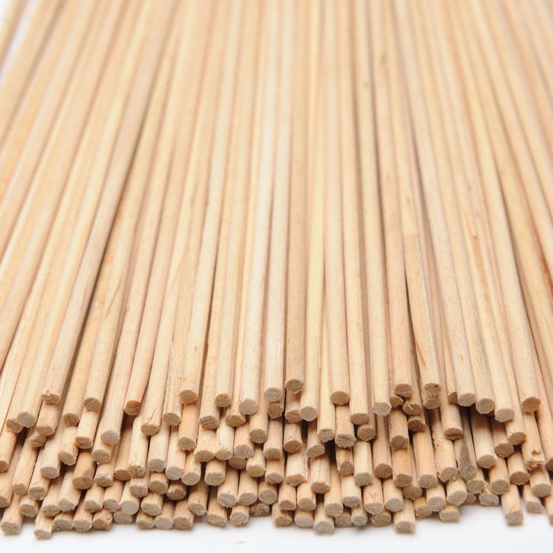 May include: A bundle of natural wooden skewers, arranged in a fan shape, with the ends of the skewers facing the viewer.