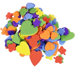 May include: A collection of colourful foam shapes in various sizes and designs. The shapes include hearts, clovers, and leaf shapes in shades of red, orange, yellow, green, blue, and purple. These craft supplies are ideal for DIY projects.