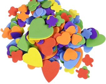 May include: A collection of colourful foam shapes in various sizes and designs. The shapes include hearts, clovers, and leaf shapes in shades of red, orange, yellow, green, blue, and purple. These craft supplies are ideal for DIY projects.