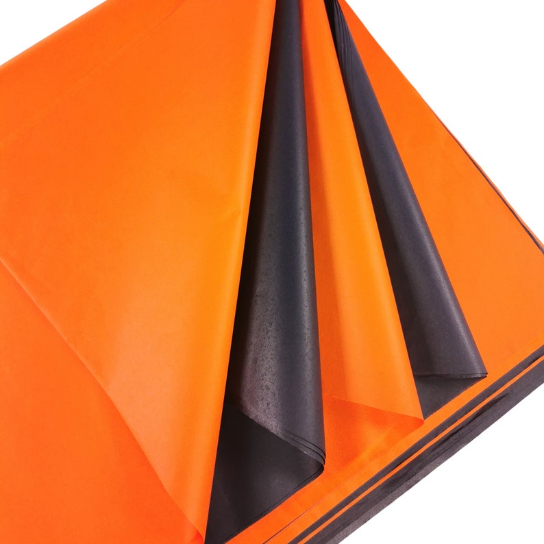 May include: Orange and black tissue paper sheets folded together. The tissue paper is thin and translucent.
