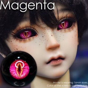 May include: A close-up of a doll's face with magenta-colored eyes. The eyes have a reptilian design with a yellow center. The word "Magenta" is at the top. The model is wearing 16mm eyes. The color of the sclera is customizable.