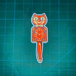 May include: A red and white cat clock with a long tail. The clock face has black numbers and hands. The cat has a white bow tie.