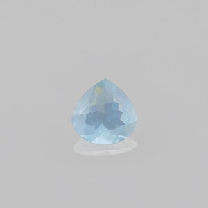 May include: A light blue teardrop-shaped gemstone with facets.