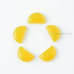 May include: Five yellow gemstone cabochons, each cut into a half-circle shape. The cabochons are arranged in a circle on a white background.