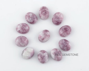 May include: A collection of 12 oval-shaped, purple and white Lepidolite cabochons. The stones are arranged in a circle on a white background.