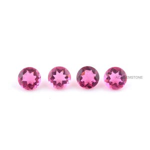 May include: Four pink round gemstones with a star-shaped facet pattern.