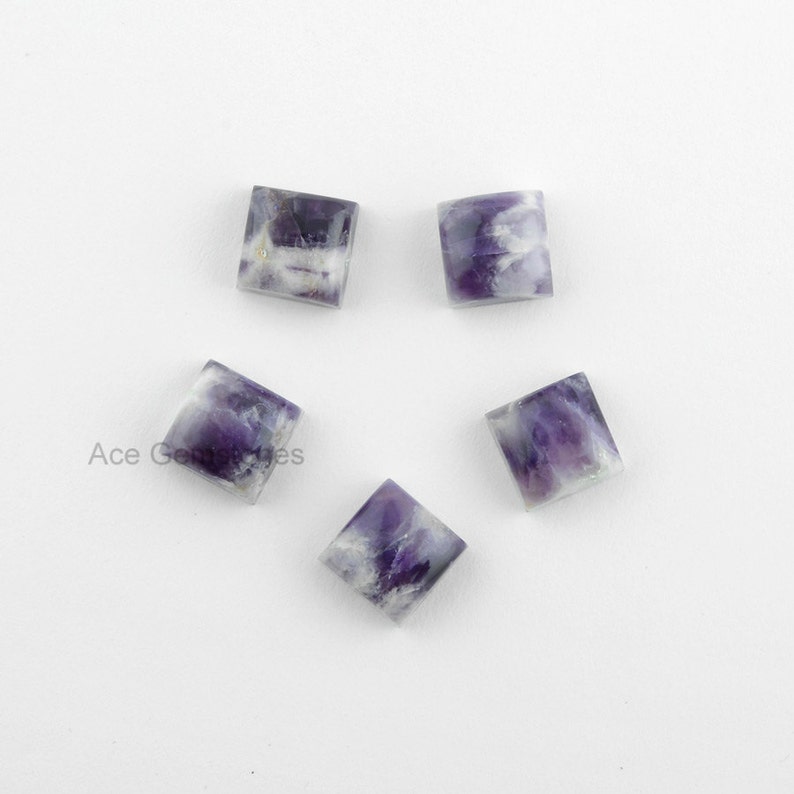 May include: Five square-shaped amethyst cabochons with a purple and white color pattern. The cabochons are approximately 10mm in size.