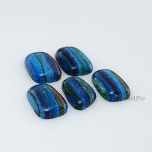 May include: Six blue, green, and brown striped cabochon gemstones. The stones are oval shaped and have a polished finish.