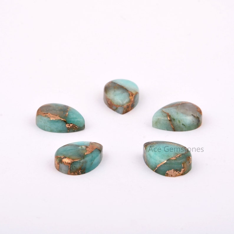 May include: Five pear-shaped green and copper gemstone cabochons. The gemstones have a mottled pattern of green and copper.