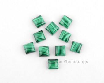 May include: Ten square-shaped green malachite cabochons with white veining. The cabochons are arranged in a scattered pattern on a white background.