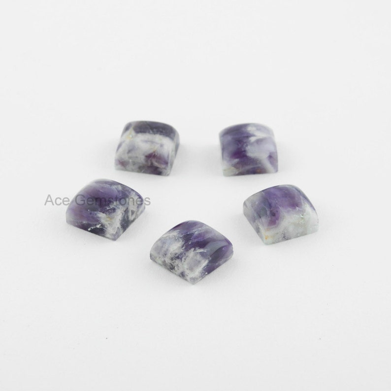 May include: Five square-shaped amethyst cabochons with a purple and white color pattern. The cabochons are approximately 10mm in size.