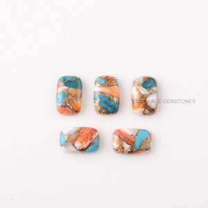 Puede incluir: Seis cabujones rectangulares de turquesa, naranja y blanco. Los cabujones est&aacute;n dispuestos en dos filas de tres. ACE GEMSTONES est&aacute; impreso en blanco sobre fondo negro en la esquina superior derecha de la imagen.