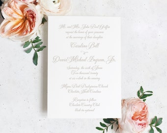 May include: A white wedding invitation card with a gray script font announcing the marriage of Caroline Bell to David Michael Ingram, Jr. on Saturday, June 6th, 2020 at 6:00 PM at Myers Park Presbyterian Church in Charlotte, North Carolina. The reception will follow at Charlotte Country Club, black tie optional.
